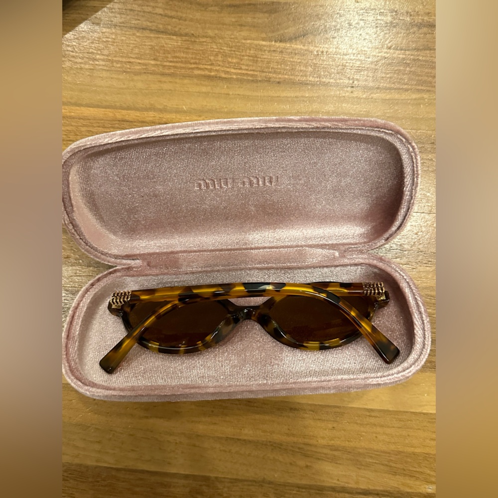 Miu Miu brown light Havana round tortoise sunglasses.